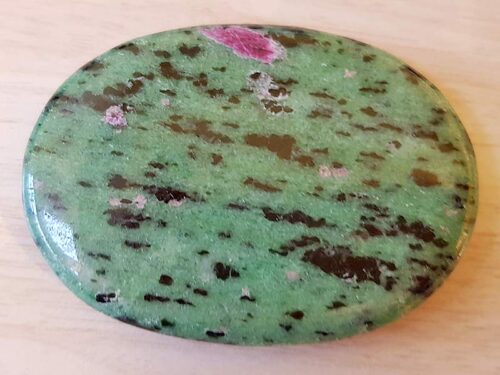 Highly polished Ruby Zoisite palm stone 70 x 40 mm. The palm stones are made from the best grade rough materials to produce a well finished, highly polished product. Used by crystal healers and general therapists for massage and similar treatments. Also perfect for collectors. Being a natural product these stones may have natural blemishes and vary in colour and banding. www.naturalhealingshop.co.uk based in Nuneaton for crystals, spiritual healing, meditation, relaxation, spiritual development,workshops.